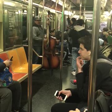 Latin band plays with bass in subway