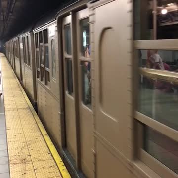 Brown subway driving off leaving platform
