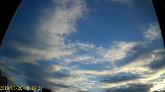 Fast flight of clouds over the city