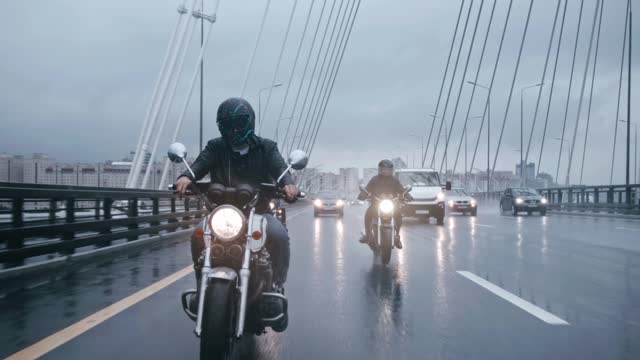 Bikers Riding On Wet Roads On A Rainy Day