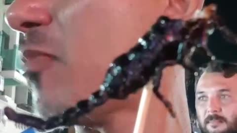 Man eating a scorpion