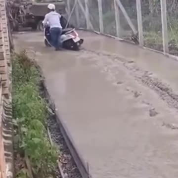 Walking over fresh concrete in front of workmen