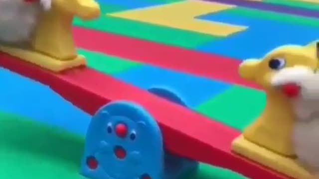 The dog is playing on the seesaw.