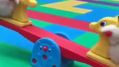 The dog is playing on the seesaw.