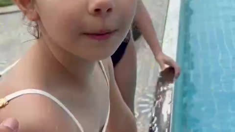 The children are swimming outdoors