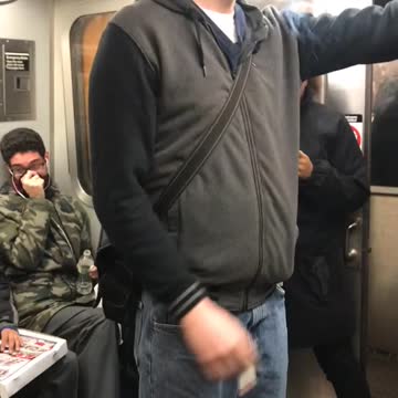 Guy smokes in the middle of subway train after being told by passengers not to