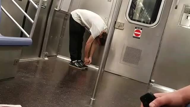 Drunk guy jumps and walks around in subway train