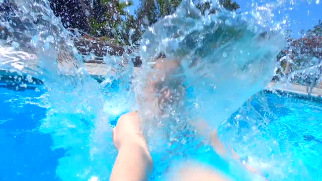 A Woman Plunging In The Pool