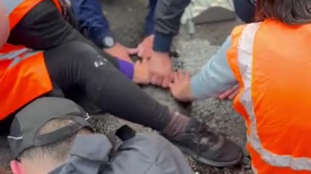 People Glueing Hands On Road