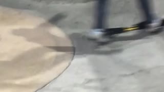 Kid rides ripstik in a skatepark