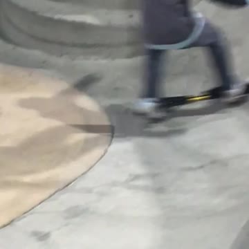 Kid rides ripstik in a skatepark
