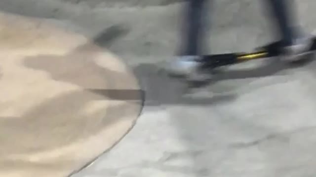 Kid rides ripstik in a skatepark