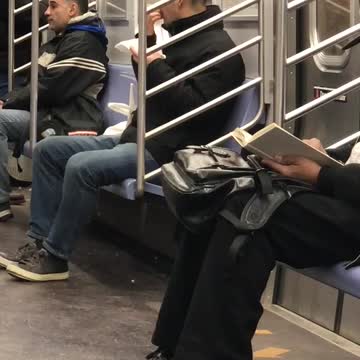 Man bites off apple skin and spits it out onto napkin on subway