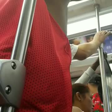 Man in red shirt dancing in subway