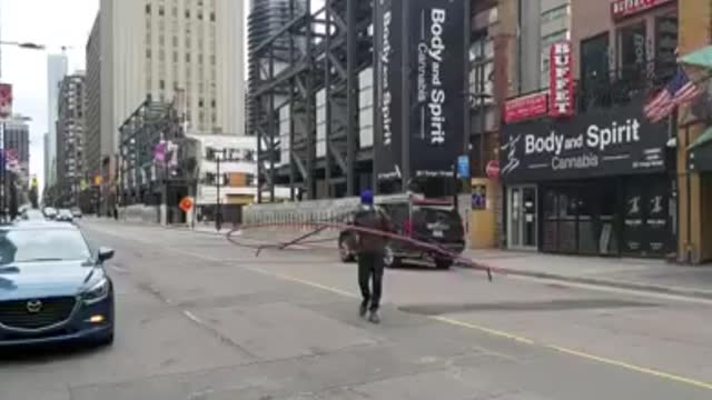 Activist Dons Weird Social Distancing Machine In Street