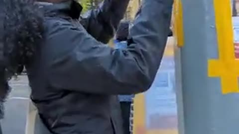 Students in NYC laugh as they rip down posters children being held hostage by Hamas