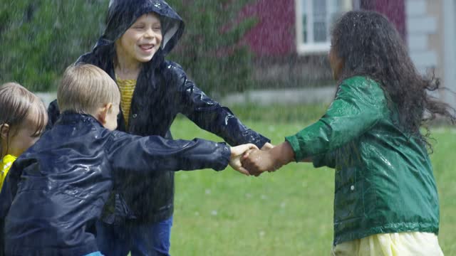 Children bathing in the rain and playing