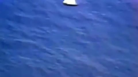 space capsule exits airplane and lands where film crew awaits