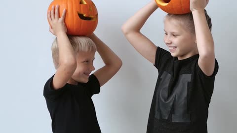 Children Posing with Halloween Pumpkin on Head