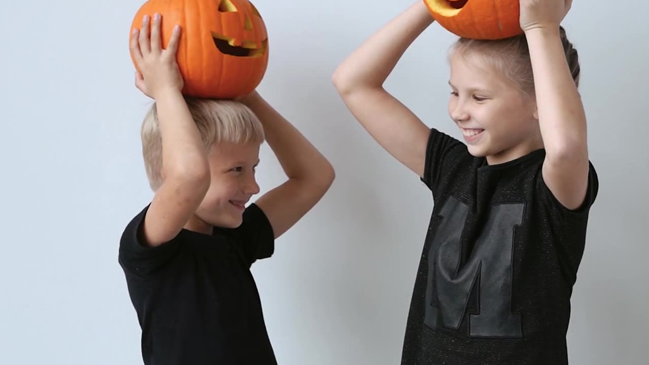 Children Posing with Halloween Pumpkin on Head