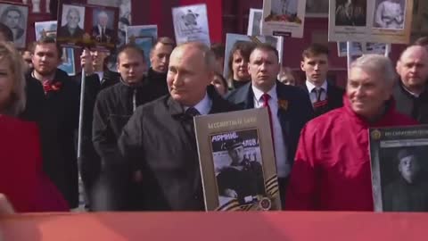 President Putin with a portrait of his father at the Immortal Regiment march