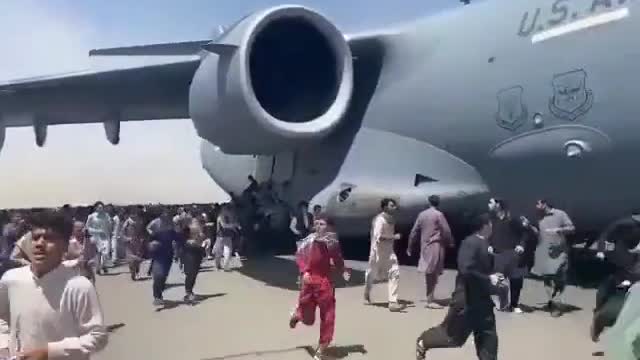 Afghani's cling to a C17 as it evacuates after surrendering