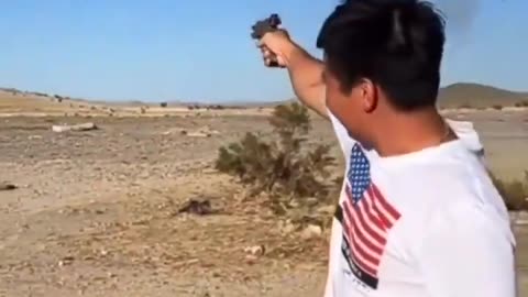 An Asian man, firing his weapon, declares a dark promise to conquer America (California)