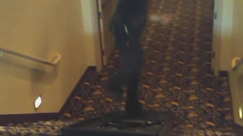 Man in black down stairs on black up side down table