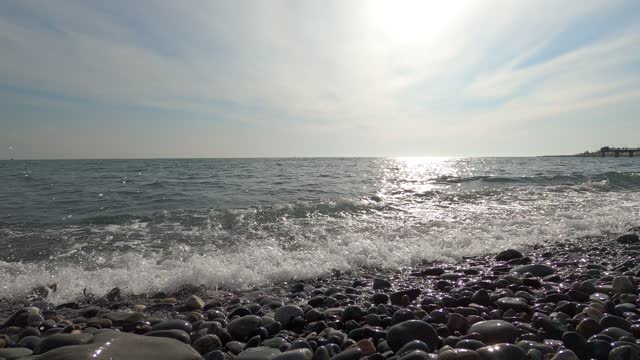 Sea waves and round pebbles