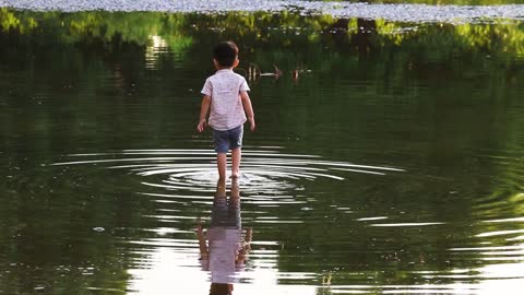 Little Boy enjoying raining water