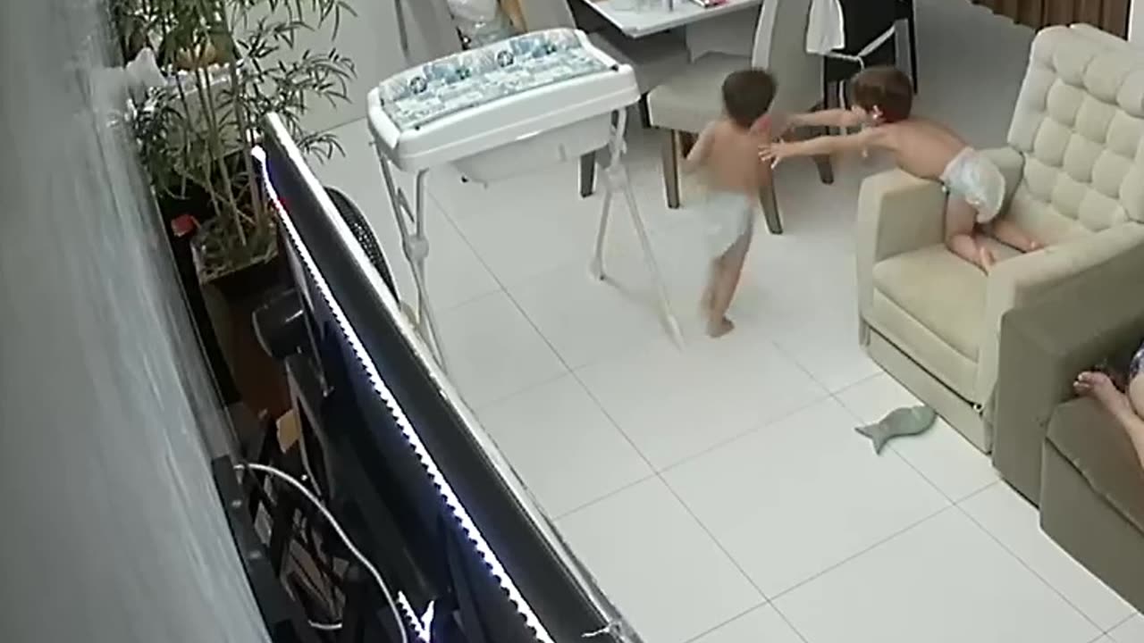 Kid Falls Off Recliner While Trying To Catch Twin