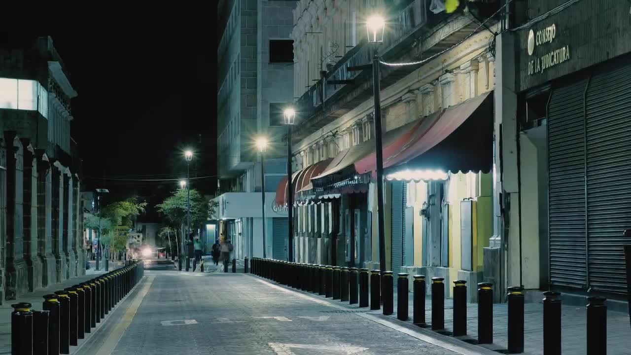 Narrow avenue at night