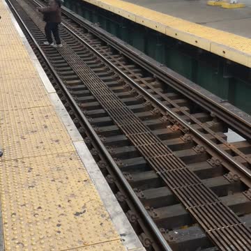 Man walks across train tracks