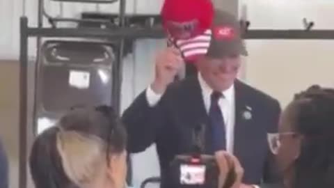 Biden Puts on a TRUMP Hat