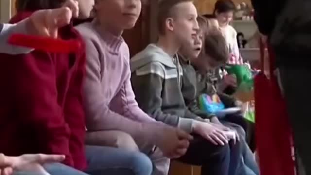 Ukrainian orphans seek shelter as an air raid siren goes off