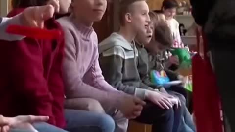 Ukrainian orphans seek shelter as an air raid siren goes off