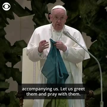 Pope Francis holds up battered Ukrainian flag sent from Bucha and kisses it.
