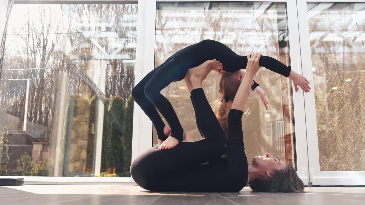 How a lovely mother teaches her cute daughter to do yoga