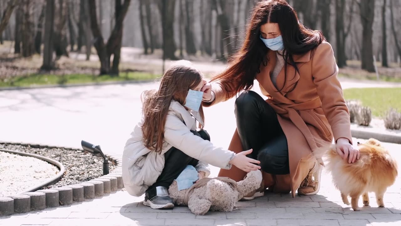 Mother and Daughter with Face Masks at the Park With Dog