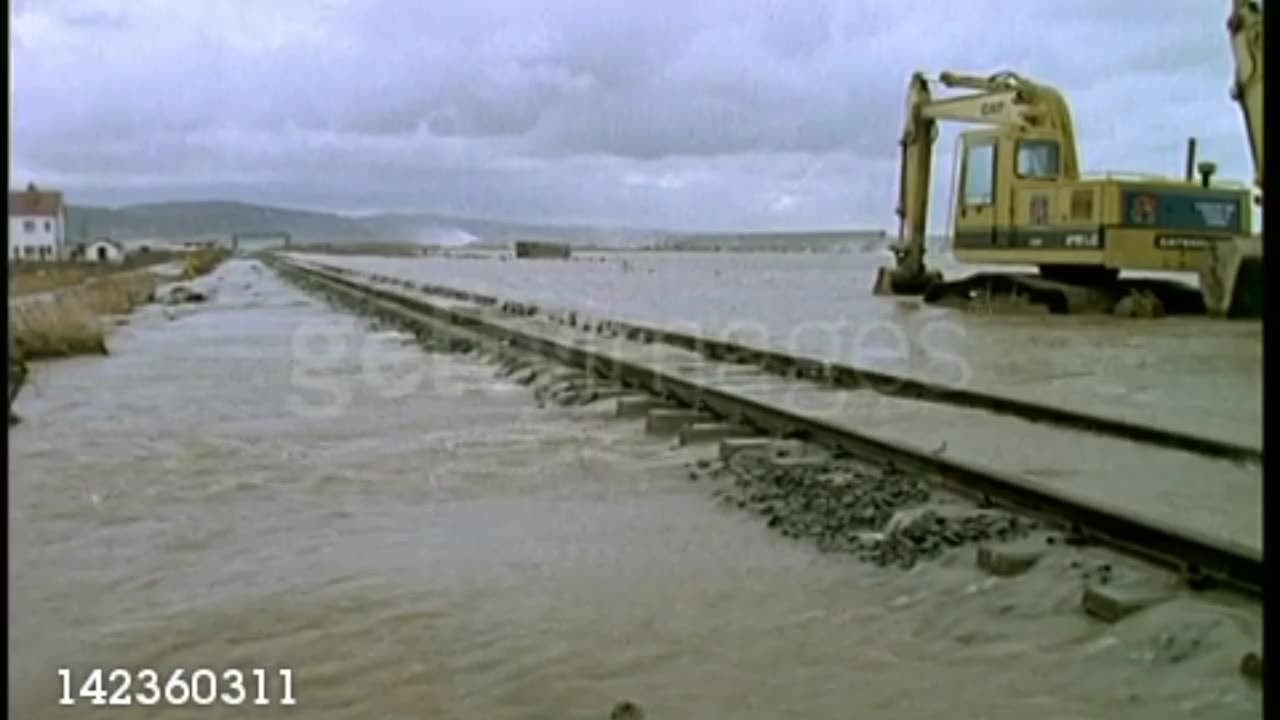 Waves breaking over sea wall, flooded train track, flood in Towyn, Wales, UK - stock video