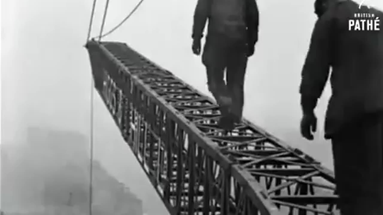 Engineers walking a crane in London in 1927