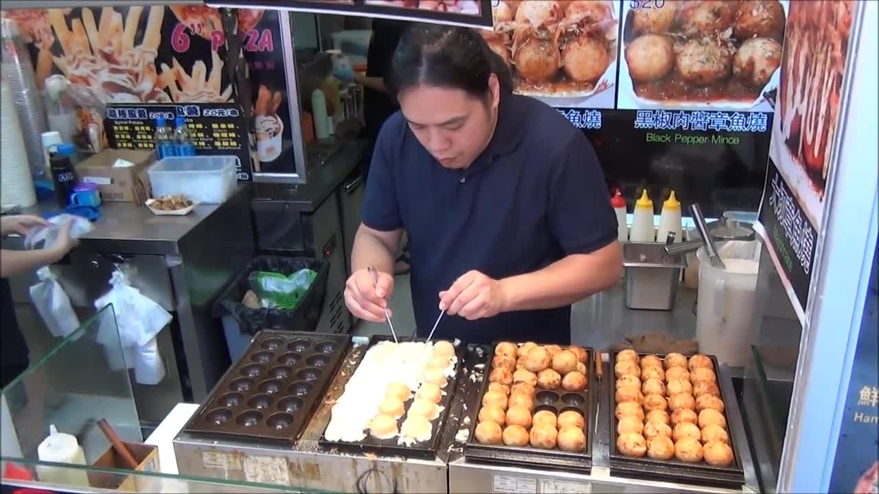 Hong Kong Street Food. Cooking Japanese Octopus Snack Takoyaki. Mong Kok, Kowloon