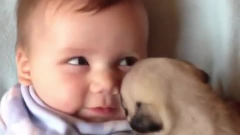 Baby kissing and cuddling puppy