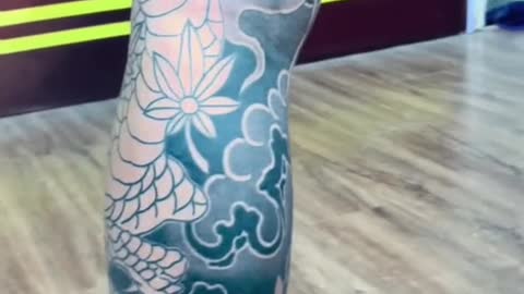 A large tattoo on one leg