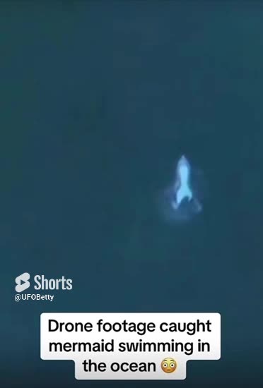 Mermaid filmed by drone swimming in ocean
