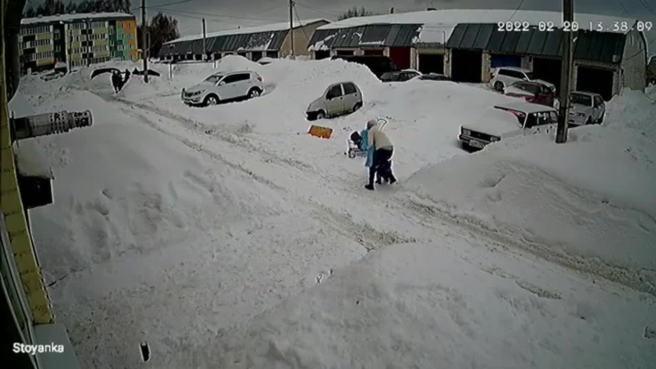 Massive Amount of Snow Slides off Roof Near Family