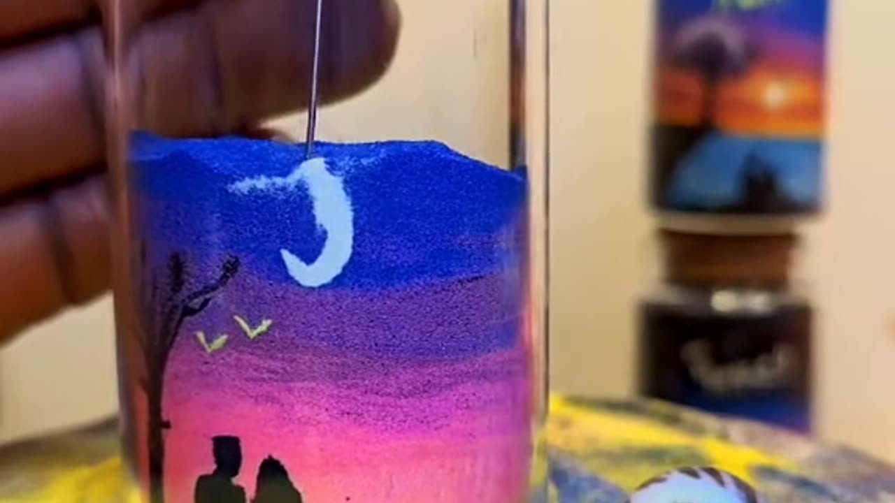 Creative sand painting in a cup, painting the sunset and the beautiful picture of the evening