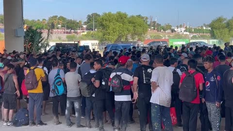 Massive number of people(Mostly men) waiting to be processed by Border Patrol.