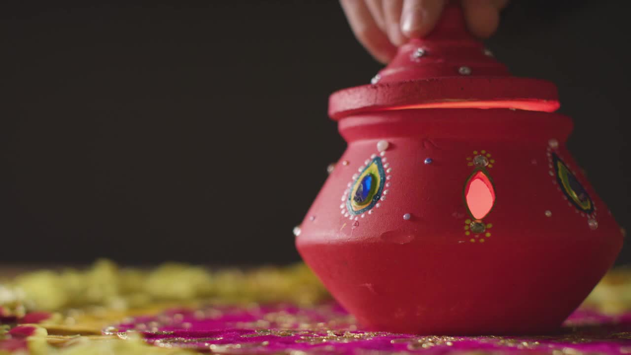 Traditional Clay Pot With Tea Lights On Table Decorated For Celebrating Festival Of Diwali