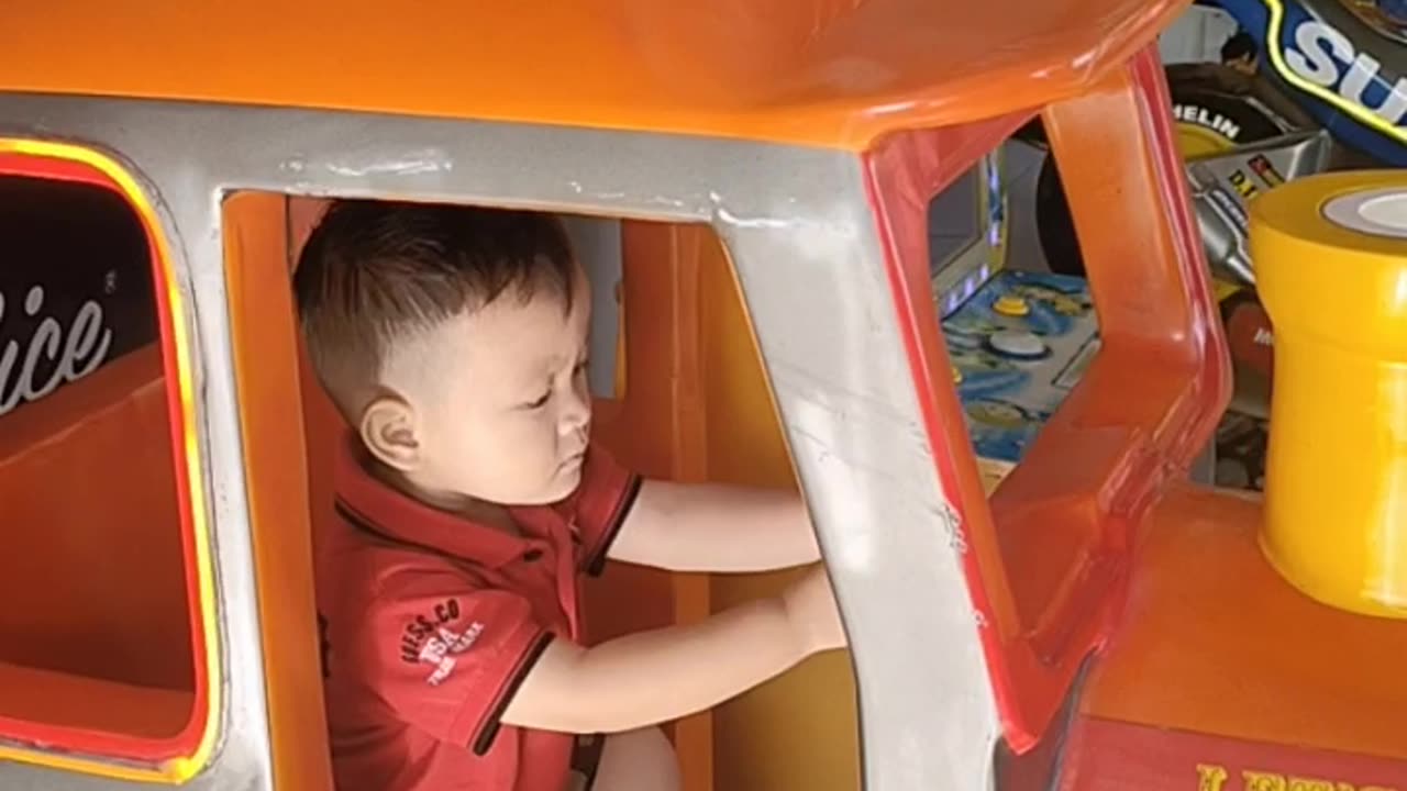 Funny baby playing with car